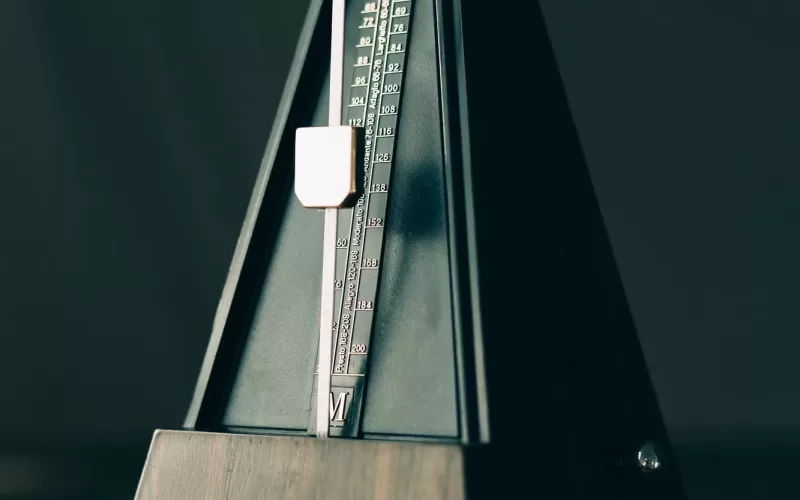 Vintage metronome, on a dark background.